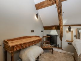 A bedroom with a desk, chair, and radiator at 1 bed property in Usk