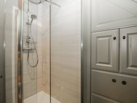 A bathroom with a shower and storage cabinet at 1 bed property Usk