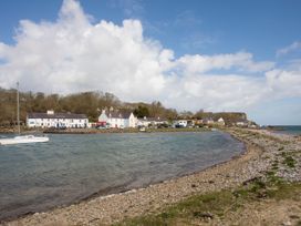 A coastal view with water and houses at Angorfa in Pentraeth
