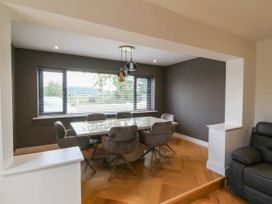 A dining room with a table and chairs at Angorfa in Pentraeth