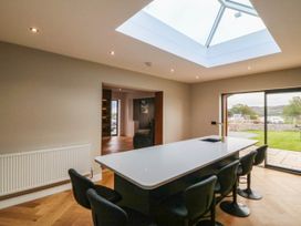 A kitchen with a skylight and an island at Angorfa in Pentraeth