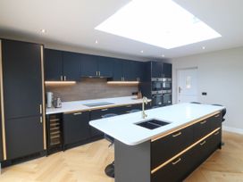A kitchen with an island and appliances at Angorfa in Pentraeth