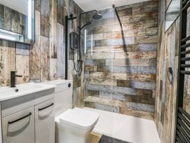 A bathroom with a shower and sink at Angorfa in Pentraeth