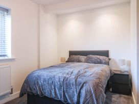 A bedroom with a bed and bedside table at Angorfa in Pentraeth