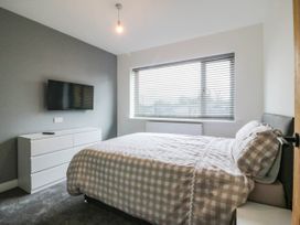 A bedroom with a bed and television at Angorfa in Pentraeth