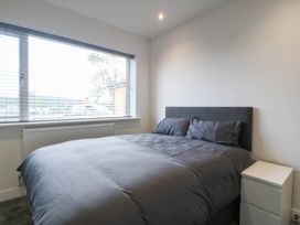 A bedroom with a bed and a window at Angorfa in Pentraeth