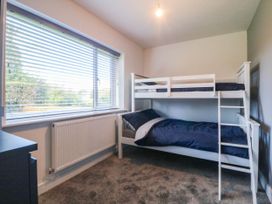 A bedroom with a bunk bed and window at Angorfa in Pentraeth