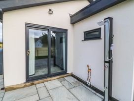 An outdoor shower next to a sliding door at Angorfa in Pentraeth