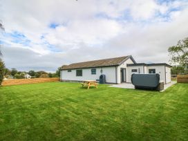 A house with a garden and seating area at Angorfa in Pentraeth