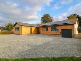 A house with a garage and solar panels at Angorfa in Pentraeth
