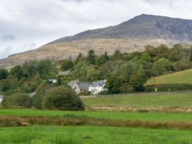 A landscape with houses and trees under a mountain at Haulfryn in Dolwyddelan