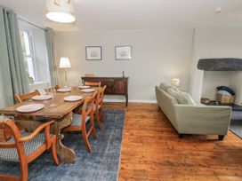 A dining room with a table and chairs at Haulfryn in Dolwyddelan