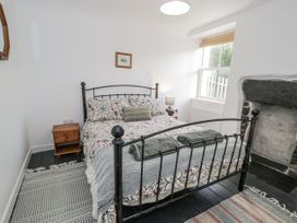 A bedroom with a bed and nightstand at Haulfryn, Dolwyddelan