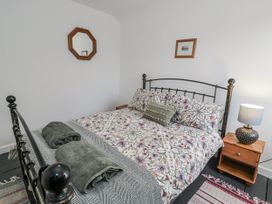 A bedroom with a bed and bedside table at Haulfryn in Dolwyddelan