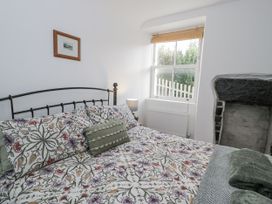 A bedroom with a bed and window at Haulfryn in Dolwyddelan