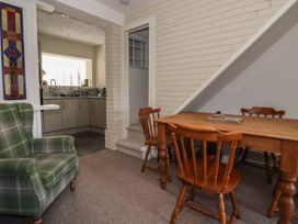 A dining room with a table and chairs at Forget Me Not Cottage in Hull