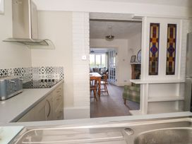 A kitchen with an extractor hood and dining area at Forget Me Not Cottage in Hull