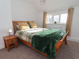 A bedroom with a bed and window at Forget Me Not Cottage in Hull