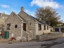 A house with stone exterior and front steps at Arum Portland Bill