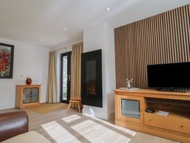 A living room with a television and media console at Arum in Portland Bill