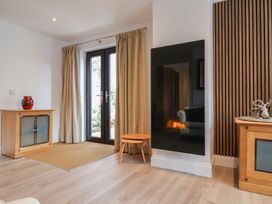 A living room with a door and curtains at Arum in Portland Bill