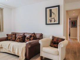 A living room with a sofa and armchair at Arum in Portland Bill