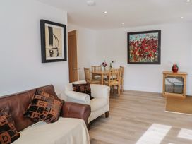 A living room with a table and chairs at Arum in Portland Bill