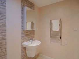 A bathroom featuring a sink and towel rail at Arum in Portland Bill