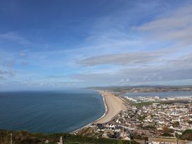 A coastal view of a beach and town at Arum in Portland Bill