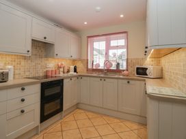 A kitchen with cabinets, sink, microwave and toaster at Evergreen in Broadway