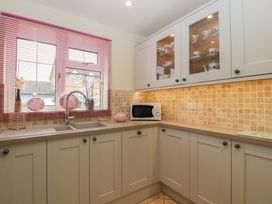 A kitchen with a sink and microwave at Evergreen in Broadway