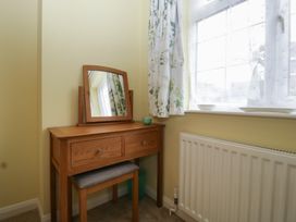 A vanity table with a mirror and stool at Evergreen in Broadway