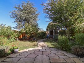 A garden with trees and a path at Evergreen in Broadway