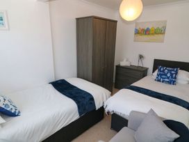 A bedroom with two beds and a wardrobe at Goetra