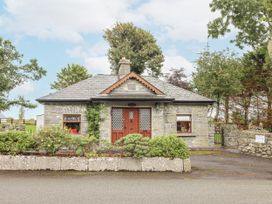 A stone house with a front door and windows at Coole Gate Lodge, Gort, County Galway