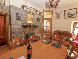 A dining room with a table and chairs at Coole Gate Lodge in Gort, County Galway