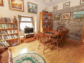 A dining room with a table and chairs at Coole Gate Lodge in Gort, County Galway