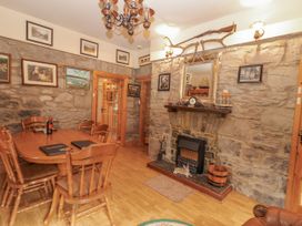A dining room with a table and chairs at Coole Gate Lodge in Gort, County Galway