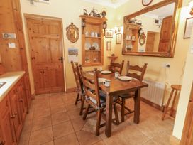 A dining room with a table and chairs at Coole Gate Lodge, Gort, County Galway