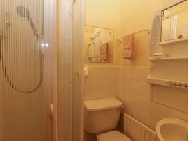 A bathroom with a shower, toilet, and sink at Coole Gate Lodge, Gort, County Galway
