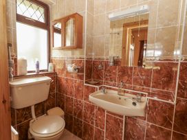 A bathroom with a toilet and sink at Coole Gate Lodge, Gort, County Galway