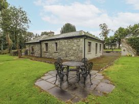 A garden with a table and chairs at Coole Gate Lodge, Gort, County Galway