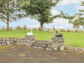 An outdoor area with stone steps and swan statues at Coole Gate Lodge in Gort, County Galway