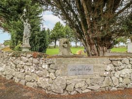 A statue and stone wall at Coole Gate Lodge in Gort, County Galway