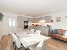 A kitchen with a table and chairs at Wellinghill Cottage at Wellinghill House Charlton Kings