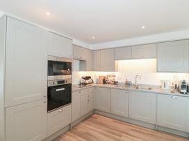 A kitchen with appliances and cabinetry at Wellinghill Cottage at Wellinghill House Charlton Kings