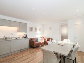 A kitchen with dining table and sofa at Wellinghill Cottage at Wellinghill House Charlton Kings