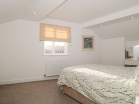 A bedroom with a bed and a window at Wellinghill Cottage at Wellinghill House Charlton Kings