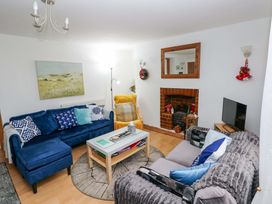 A living room with sofas and a coffee table at Tawe Cottage in Swansea