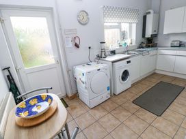 A kitchen with a washing machine and tumble dryer at Tawe Cottage in Swansea